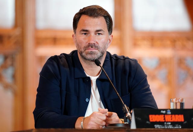 Promoter Eddie Hearn sat at a table during a press conference