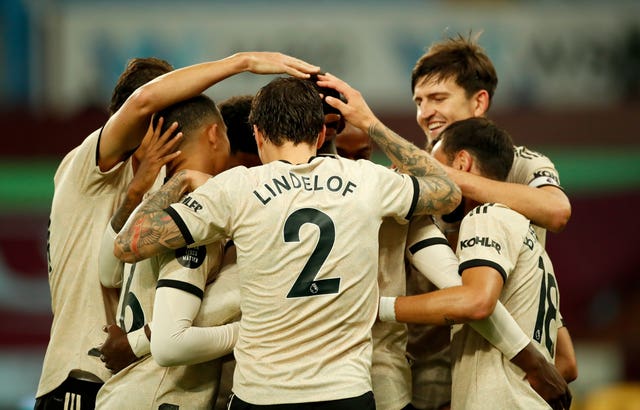 Manchester United's Paul Pogba celebrates with team-mates after scoring his side's third