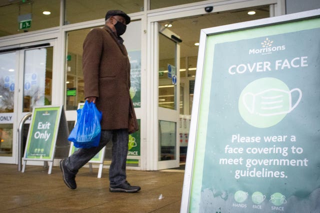 A shopper wearing a face mask outside a Morrisons store