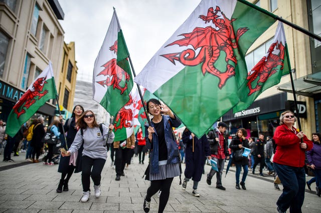 People take part in a St David’s Day Parade in Cardiff