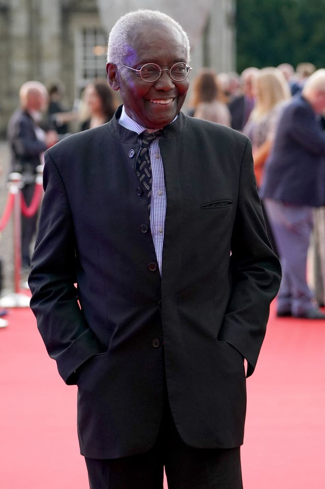Sir Geoff Palmer smiling at a red carpet event
