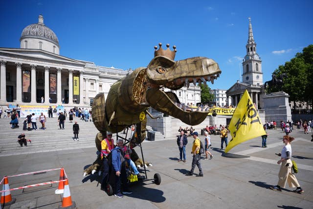 A 15ft dinosaur mascot called Chuck the Rex stands in Trafalgar Square as part of anti-monarchy protests