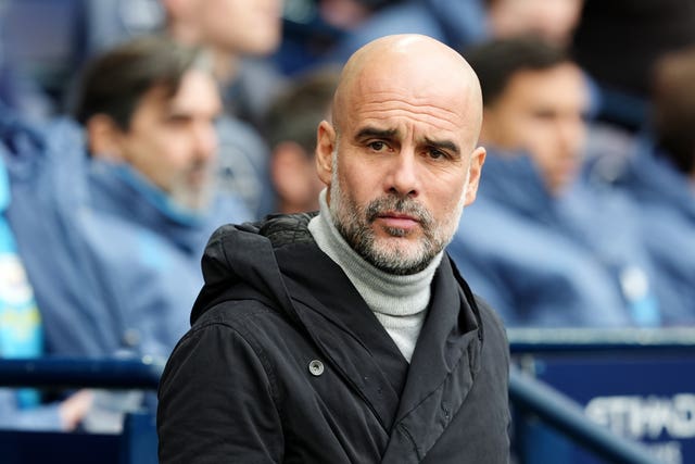 Profile shot of Pep Guardiola managing Manchester City