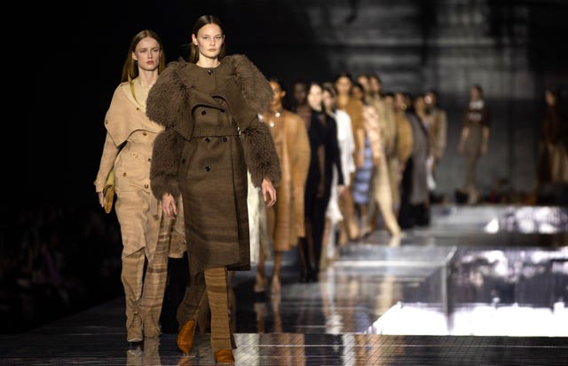 Models on a catwalk wearing Burberry designs