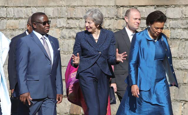 Prime Minister Theresa May (3rd right) and Commonwealth Secretary-General Patricia Scotland (right) walk with Sierra Leone's President Julius Maada Bio (left) as they arrive to hold talks at Windsor Castle. (Andrew Matthews/PA)