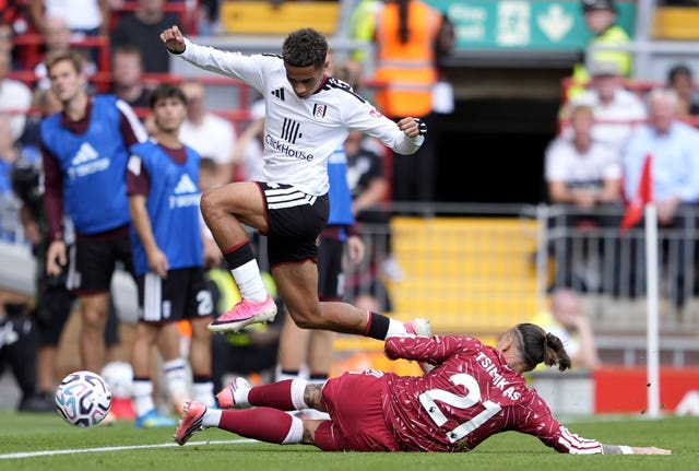 Liverpool’s Kostas Tsimikas (right) challenges Fulham’s Josh King