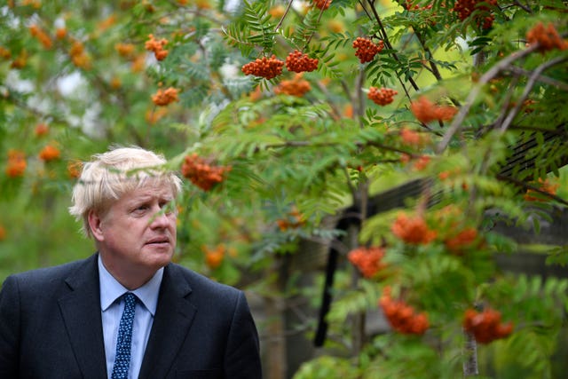 Boris Johnson with a tree (Neil Hall/PA)