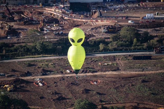 An alien hot air balloon floating high above the ground