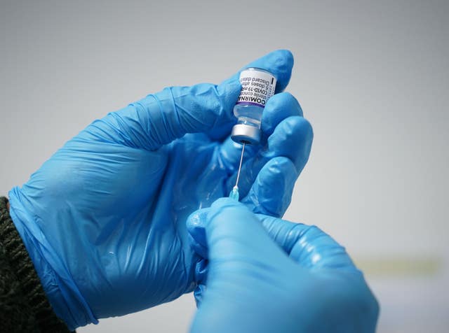 A dose of the Pfizer booster jab is prepared (Yui Mok/PA)