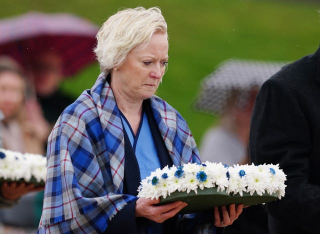 Chief Nursing Officer Ruth May lays a wreath