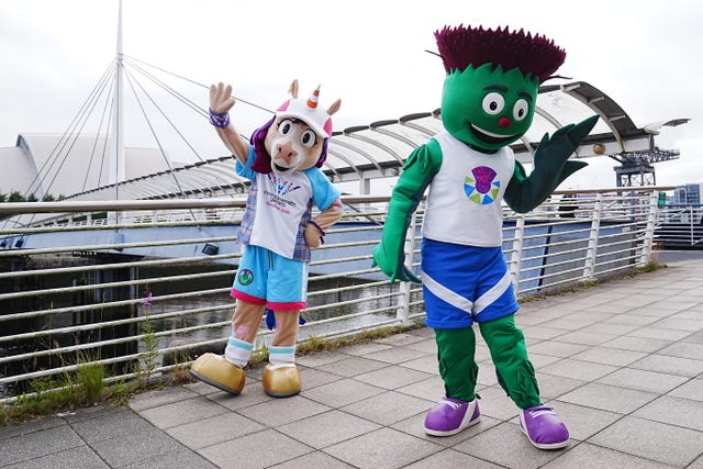 Commonwealth Games mascots Finnie the unicorn and Clyde the thistle posing on a bridge