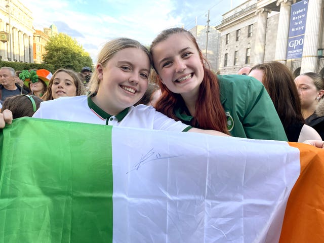 Aspiring footballers Ellie Young, 19, and Kelly Snow, 17, hold up an Irish tricolour flag signed by captain Katie McCabe