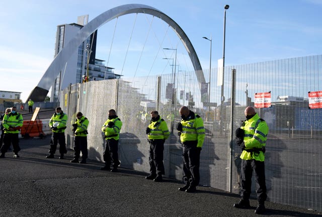 Police officers observe a two-minute silence to remember the war dead on Armistice Day at the entrance to the Cop26 summit at the Scottish Event Campus (SEC) in Glasgow