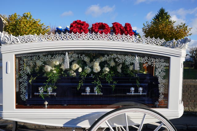 A horse-drawn carriage carrying the coffin of Liam Payne arrives for the funeral service of the One Direction singer