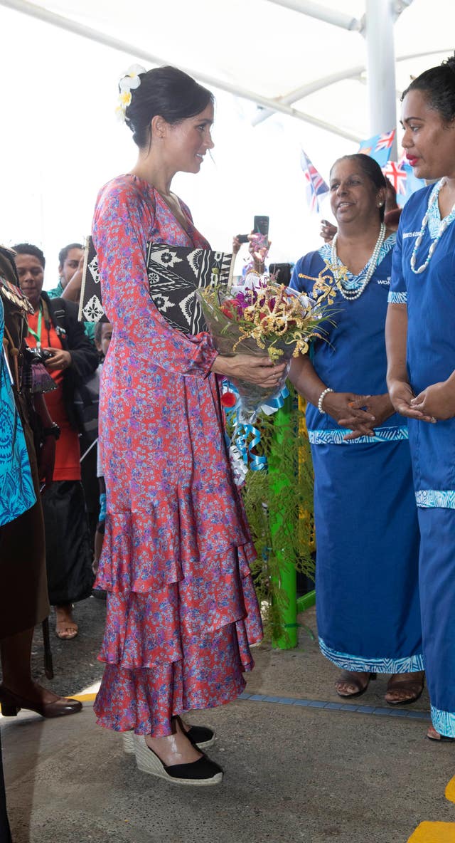 Meghan was given a bouquet of flowers during her visit to Suva Market