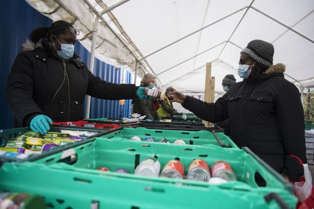 People receive food from the Ringcross Foodbank, in north London, where vension is being served