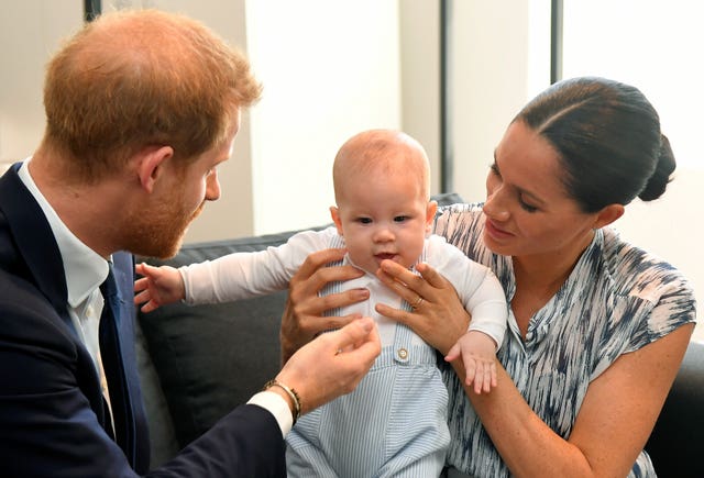 The Duke and Duchess of Sussex holding their son Archie in 2019