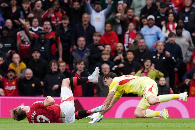 Aston Villa goalkeeper Emiliano Martinez, right, brings down Manchester United’s Rasmus Hojlund