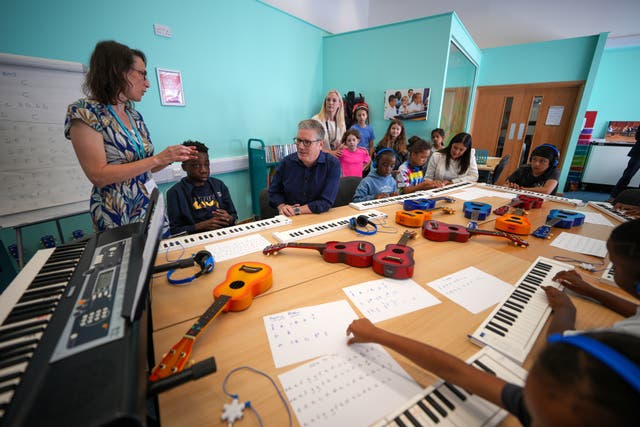 Sir Keir Starmer and Lisa Nandy sitting around a table in a classroom with children and a teacher