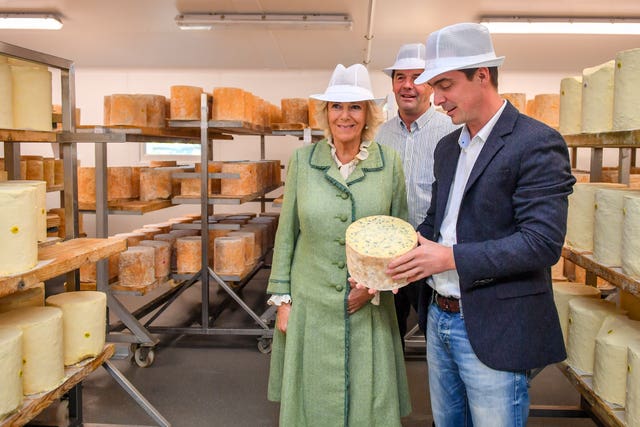 The Duchess of Cornwall is shown a blue cheese by Hugh Hadfield during her visit