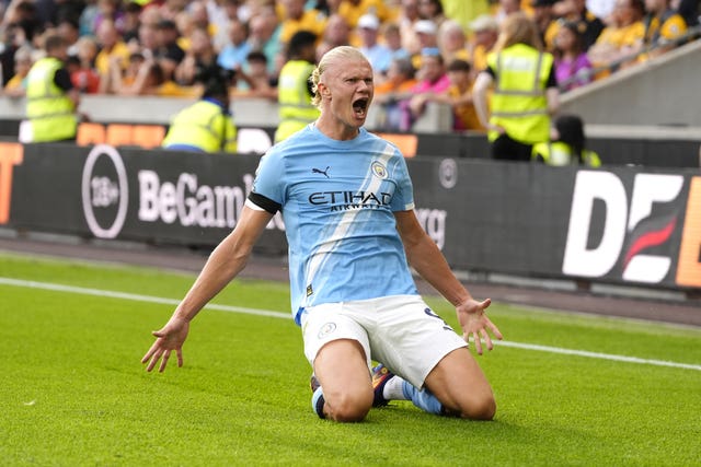 Erling Haaland slides on his knees to celebrate a goal