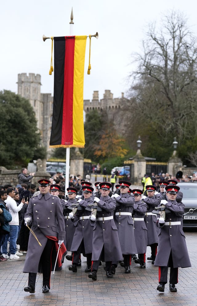 German flags on show in Windsor as members of 4th Regiment Royal Artillery march out of the castle ahead of the state visit