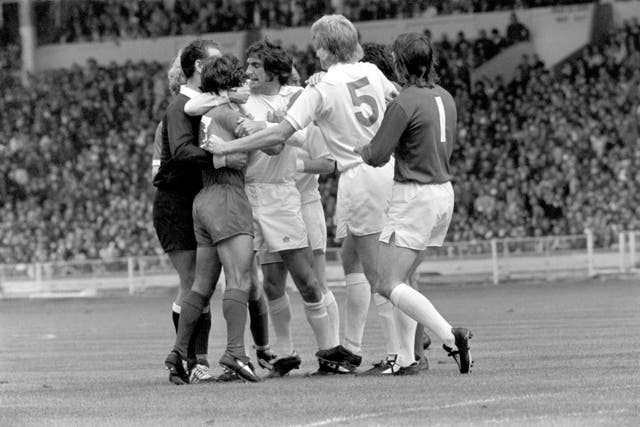 Leeds' Norman Hunter (centre) and referee Bob Matthewson restrain Liverpool's Kevin Keegan (second left) after he and Billy Bremner had clashed