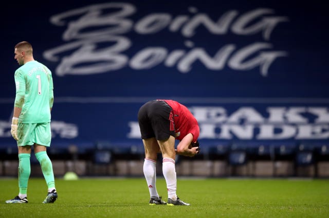 Harry Maguire holds his head in his heads after being denied at the death