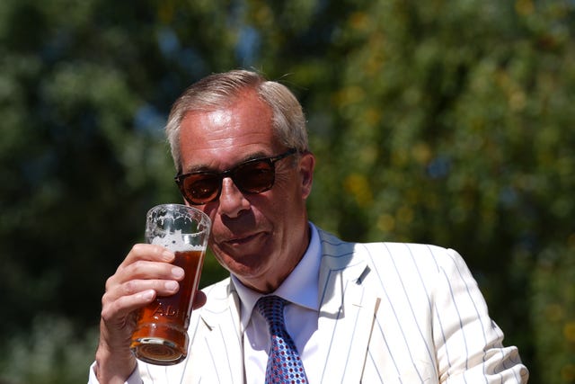 Reform UK leader Nigel Farage enjoys a pint in Clacton after voting in the Clacton by-election