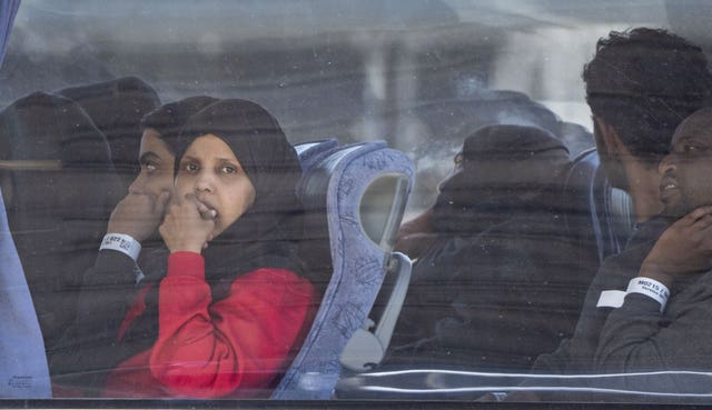 People believed to be migrants leaving Dover, Kent, by bus on Monday following small boat crossings in the Channel