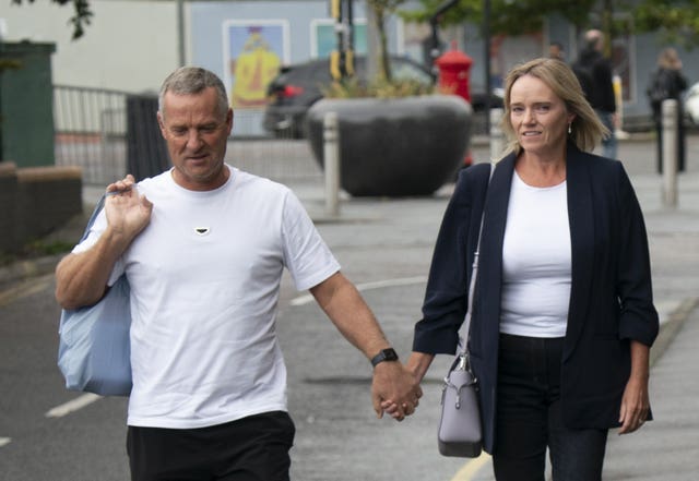 Sandie Peggie walking holding hands with her husband