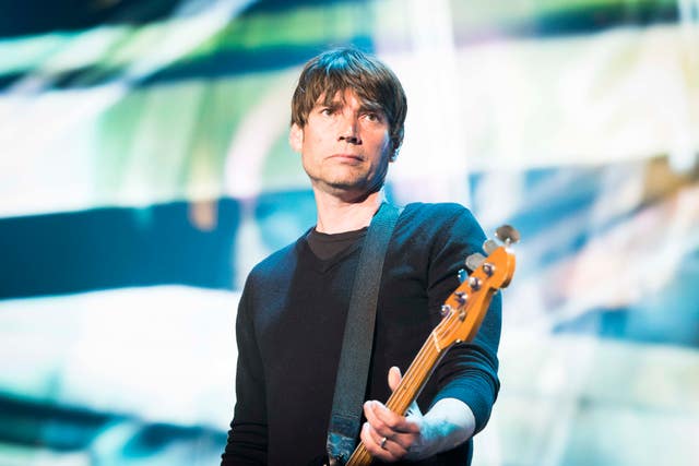Alex James performing