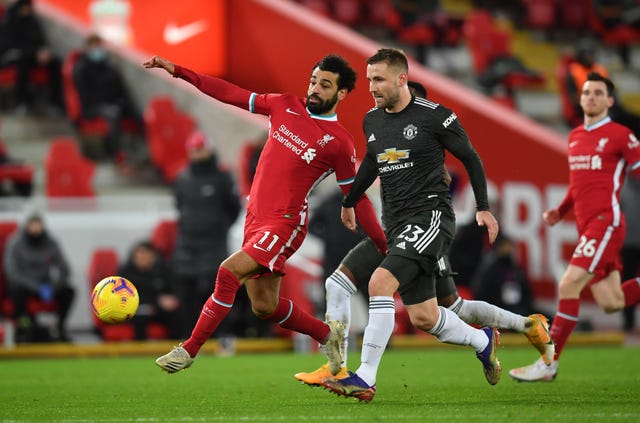 Liverpool's Mohamed Salah and Manchester United's Luke Shaw battle for the ball. 