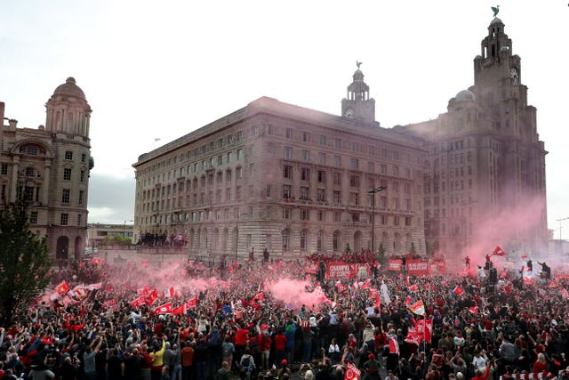 The buses pass the Liver Building