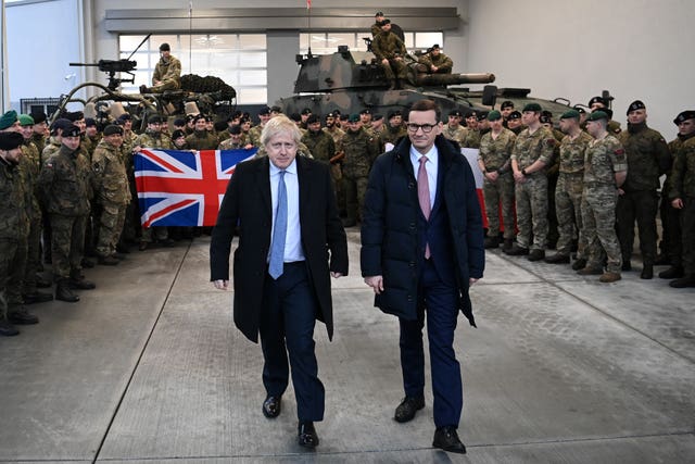 Prime Minister Boris Johnson with British troops during a visit with Polish Prime Minister Mateusz Morawiecki to Warszawska Brygada Pancerna military base near Warsaw