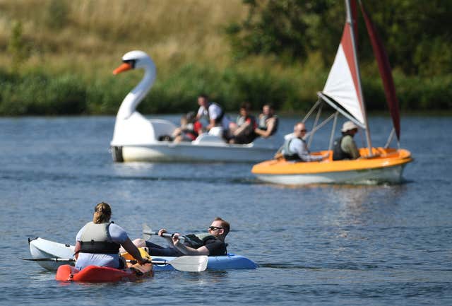 People relax on kayaks at Nene Park in Peterborough, as the warm weather continues (Joe Giddens/PA)