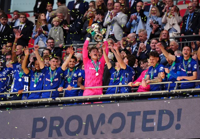 Rochdale players celebrate with the trophy after winning the Enterprise National League Play-off final