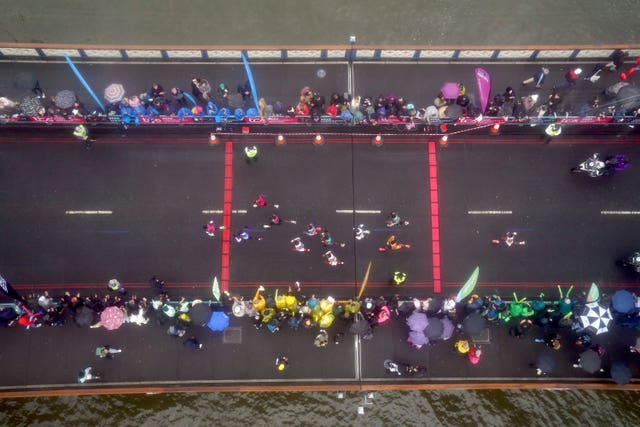 Athletes in the men’s elite race cross Tower Bridge