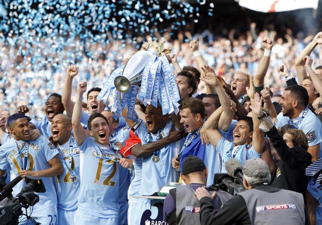 Manchester City captain Vincent Kompany lifts the Premier League trophy (PA)