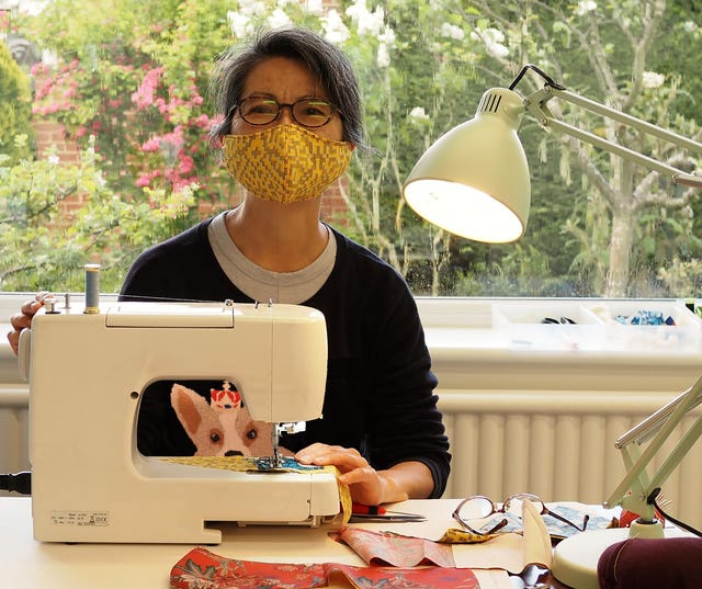 A photo issued by Historic England from its Picturing Lockdown Collection entitled Masako sewing masks, taken by Peter Crush in Reading, Berkshire