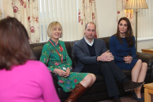 The Duke and Duchess of Cambridge and health visitor Amanda Pollock, left, speak with parents at the SureStart centre