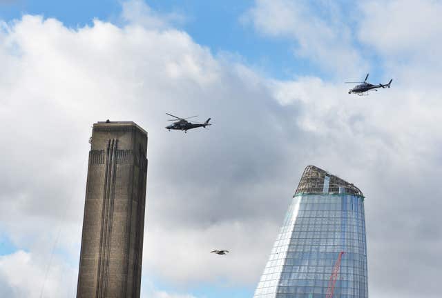 A pair of helicopters circle the chimney top of the Tate Modern gallery in London for another death-defying scene, set to appear in Mission: Impossible 6.