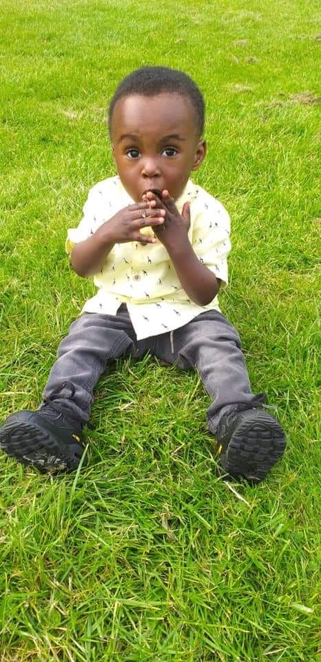Awaab Ishak sits on the grass