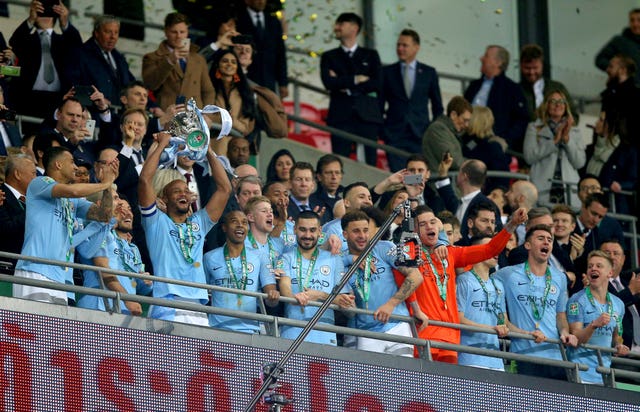 Manchester City collect the Carabao Cup trophy after beating Chelsea in the final