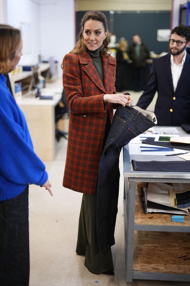 Kate holding a pair of jeans
