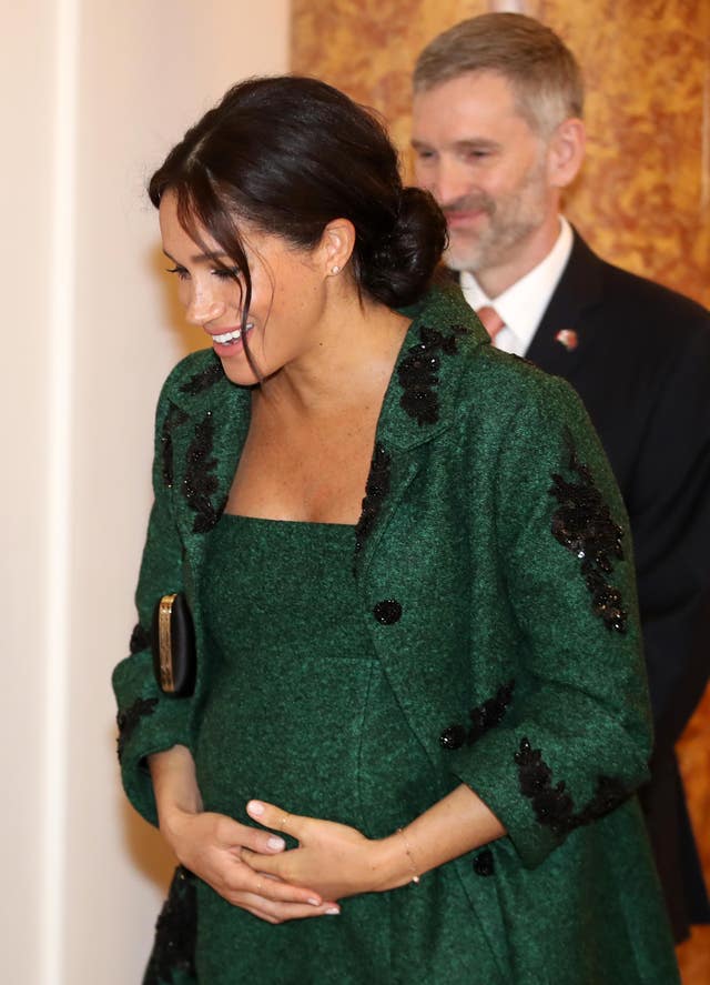 Meghan holding her bump