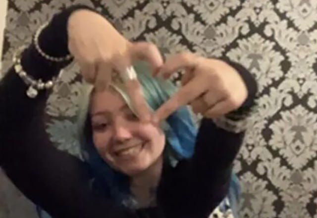 Morgan Dorsett smiling and making a love heart with her fingers