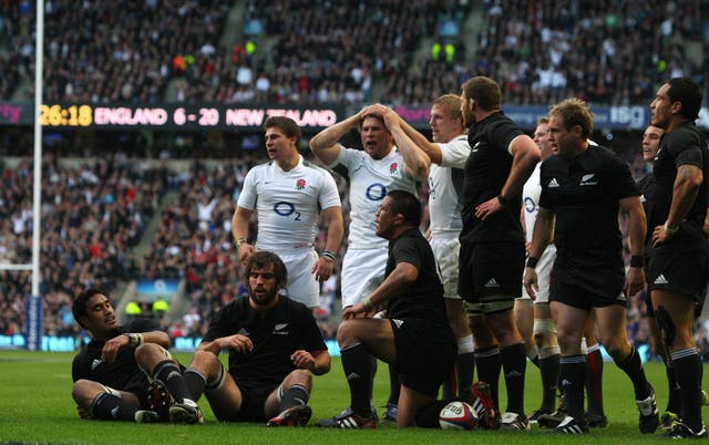 Hartley (top centre) is congratulated by his teammates after scoring a try during an International match at Twickenham against New Zealand