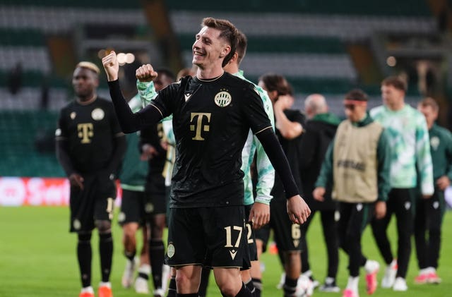 Ferencvaros’ Marius Corbu celebrates in front of the fans after the game