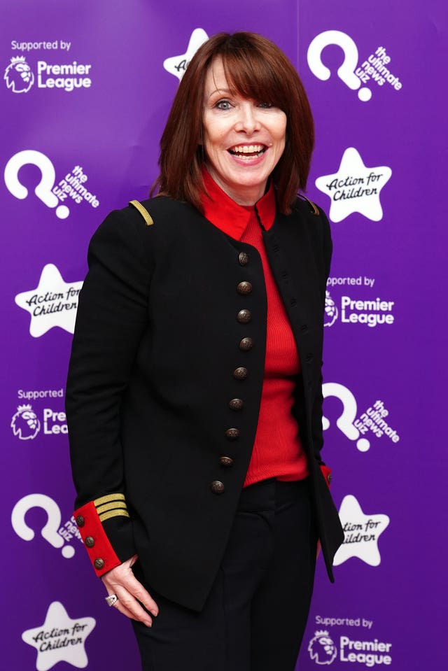 Kay Burley in a red top and black jacket